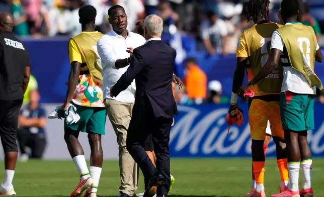 Senegal head coach Pape Thiaw, left, shakes hands with France head coach Didier Deschamps at the end of during the World Cup Group I soccer match between France and Senegal in East Rutherford, N.J., near New York, Tuesday, June 16, 2026. (AP Photo/Yuki Iwamura)
