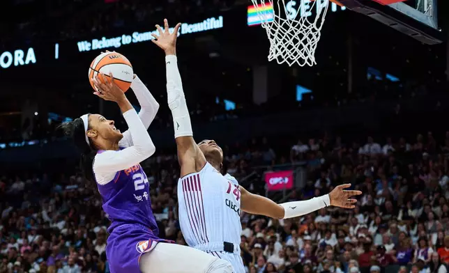Phoenix Mercury's DeWanna Bonner (24) drives to the net past Toronto Tempo's Temi Fagbenle (14) during first half of an WNBA basketball game in Toronto, on Saturday, June 27, 2026. (Sammy Kogan /The Canadian Press via AP)