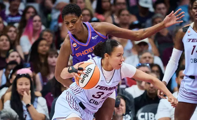 Toronto Tempo's Tima Pouye (32) drives past Phoenix Mercury's Valeriane Ayayi (11) during first half of an WNBA basketball game in Toronto, on Saturday, June 27, 2026. (Sammy Kogan /The Canadian Press via AP)