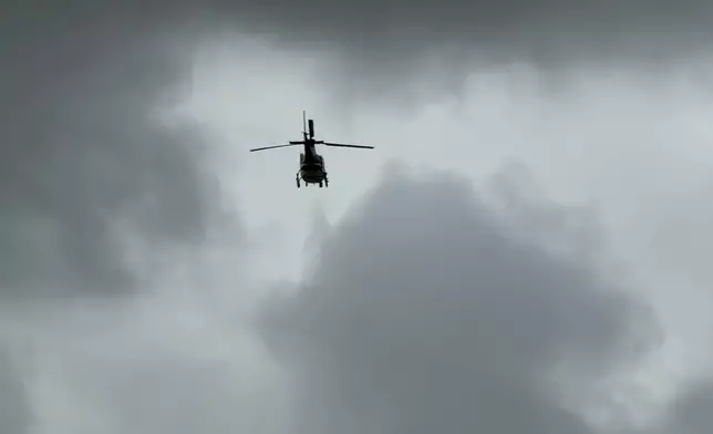 A helicopter flys over an active shooting scene Friday, June 12, 2026, in Midland, Texas. (Luke Dias/Reporter-Telegram via AP)