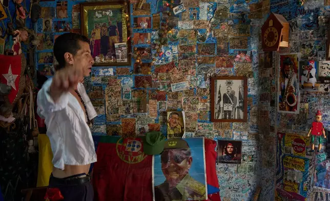 A souvenir shop worker gestures next to images of Raul Castro, Che Guevara and Jose Marti in Havana, Tuesday, June 2, 2026. (AP Photo/Ramon Espinosa)