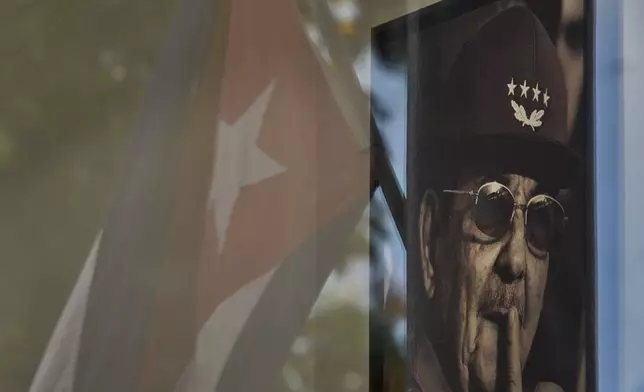 A photo of Raul Castro is seen with a reflected Cuban flag in a state store in Havana, Cuba, Tuesday, June 2, 2026. (AP Photo/Ramon Espinosa)