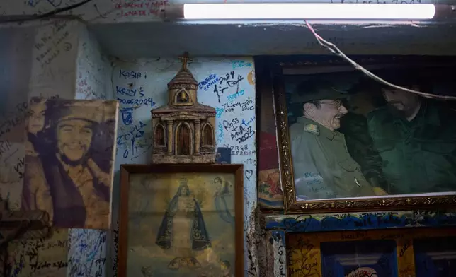 Images of Che Guevara, Virgin of Charity, Raúl Castro, and Fidel Castro hang on a wall in a souvenir shop in Havana, Tuesday, June 2, 2026. (AP Photo/Ramon Espinosa)