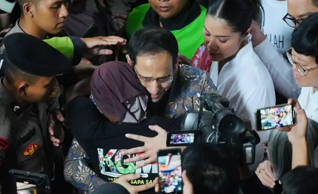The co-founder of ride-hailing and payment giant Gojek and fomer Indonesian Education Minister Nadiem Anwar Makarim, center, is hugged by a supporter as his wife Franka, top right, looks on after being sentenced in a Google Chromebook laptop procurement corruption case, at the Corruption Court in Jakarta, Indonesia, Tuesday, June 30, 2026. (AP Photo/Tatan Syuflana)
