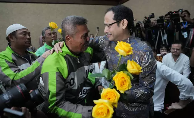Fomer Education Minister Nadiem Anwar Makarim, also the co-founder of ride-hailing and payment giant Gojek, is greeted by supporters before his sentencing hearing in a Google Chromebook laptop procurement corruption case, at the Corruption Court in Jakarta, Indonesia, Tuesday, June 30, 2026. (AP Photo/Tatan Syuflana)