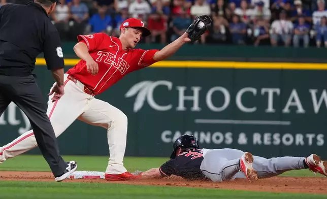 Cleveland Guardians' Travis Bazzana, right, steals second base against Texas Rangers shortstop Corey Seager, second from left, during the third inning of a baseball game, Friday, June 5, 2026, in Arlington, Texas. (AP Photo/LM Otero)