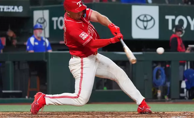 Texas Rangers' Wyatt Langford hits a double during the sixth inning of a baseball game against the Cleveland Guardians, Friday, June 5, 2026, in Arlington, Texas. (AP Photo/LM Otero)