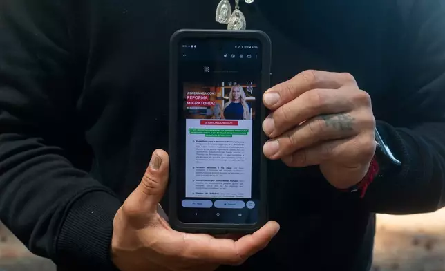 Gabriel Martinez Garcia, 30, poses with an email advertisement from attorney Lozano displayed on his phone in Tenino, Wash., on Sunday, June 14, 2026. . (AP Photo/Akash Pamarthy)