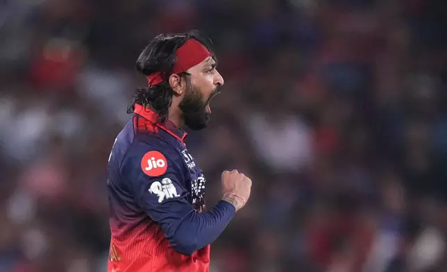 Royal Challengers Bengaluru's Krunal Pandya celebrates the wicket of Gujarat Titans' Jos Buttler during the Indian Premier League final cricket match between Gujarat Titans and Royal Challengers Bengaluru in Ahmedabad, India, Sunday, May 31, 2026. (AP Photo/Ajit Solanki)