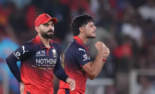 Royal Challengers Bengaluru's Rasikh Dar celebrates the wicket of Gujarat Titans' Nishant Sindhu during the Indian Premier League final cricket match between Gujarat Titans and Royal Challengers Bengaluru in Ahmedabad, India, Sunday, May 31, 2026. (AP Photo/Ajit Solanki)
