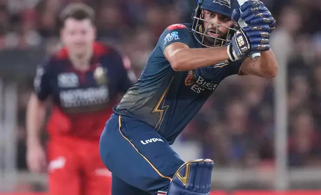 Gujarat Titans' Washington Sundar plays a shot during the Indian Premier League final cricket match between Gujarat Titans and Royal Challengers Bengaluru in Ahmedabad, India, Sunday, May 31, 2026. (AP Photo/Ajit Solanki)