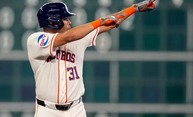 Houston Astros' LaMonte Wade Jr. reacts after hitting a two-run double against the Athletics during the fifth inning of a baseball game, Saturday, June 6, 2026, in Houston. (AP Photo/Eric Christian Smith)