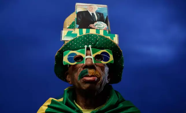 A Brazil fan poses before watching the World Cup match between Brazil and Morocco at Copacabana beach in Rio de Janeiro, Brazil, Saturday, June 13, 2026. (AP Photo/Bruna Prado)