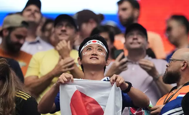 A fan of Japan holds his country's flag prior to the World Cup Group F soccer match between the Netherlands and Japan in Arlington, Texas, near Dallas, Sunday, June 14, 2026. (AP Photo/Julio Cortez)