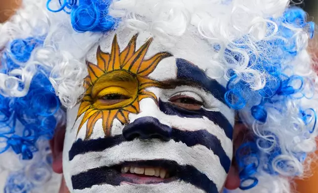 A fan of Uruguay smiles prior to the World Cup Group H soccer match between Saudi Arabia and Uruguay in Miami Gardens, Fla., Monday, June 15, 2026. (AP Photo/Rebecca Blackwell)