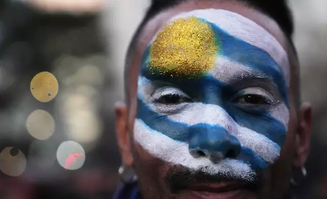 A fan gathers to watch the World Cup soccer match between Uruguay and Saudi Arabia, in Montevideo, Uruguay Monday, June 15, 2026. (AP Photo/Matilde Campodonico)