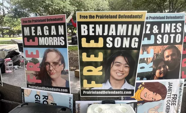 Supporters of protesters convicted over a shooting outside a Texas immigration detention center display signs in support of the defendants outside a federal courthouse in Fort Worth, Texas on Tuesday, June 23, 2026. (AP Photo/Kendria LaFleur)