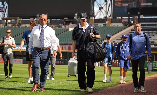 Los Angeles Dodgers' Shohei Ohtani enters the field prior to a baseball game against the Chicago White Sox, Friday, June 12, 2026, in Chicago. (AP Photo/Melissa Tamez)