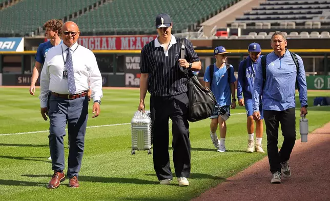 Los Angeles Dodgers' Shohei Ohtani enters the field prior to a baseball game against the Chicago White Sox, Friday, June 12, 2026, in Chicago. (AP Photo/Melissa Tamez)
