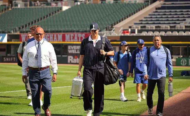 Los Angeles Dodgers' Shohei Ohtani enters the field prior to a baseball game against the Chicago White Sox, Friday, June 12, 2026, in Chicago. (AP Photo/Melissa Tamez)