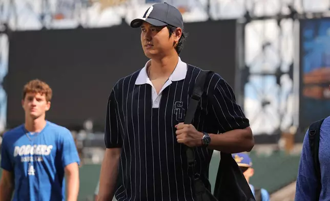 Los Angeles Dodgers' Shohei Ohtani enters the field prior to a baseball game against the Chicago White Sox, Friday, June 12, 2026, in Chicago. (AP Photo/Melissa Tamez)