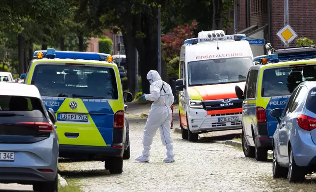 Forensic investigators on a street in Stade, Germany Monday, June 29, 2026 following a shooting. (Ulrich Perrey/dpa/dpa via AP)
