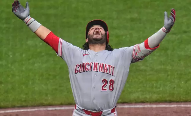 Cincinnati Reds' Eugenio Suárez celebrates as he crosses home plate after hitting a three-run home run off Pittsburgh Pirates pitcher Gregory Soto during the ninth inning of a baseball game in Pittsburgh, Saturday, June 27, 2026. (AP Photo/Gene J. Puskar)