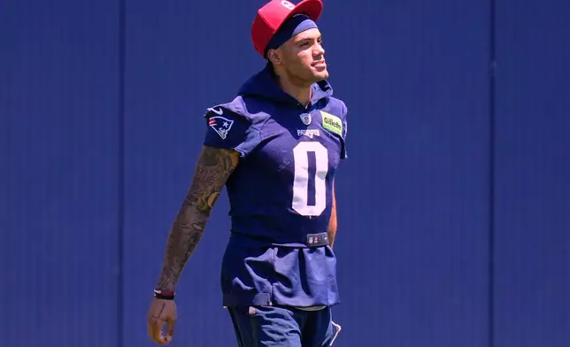 New England Patriot's Christian Gonzalez arrives for an NFL football practice, Tuesday, June 9, 2026, in Foxborough, Mass. (AP Photo/Charles Krupa)