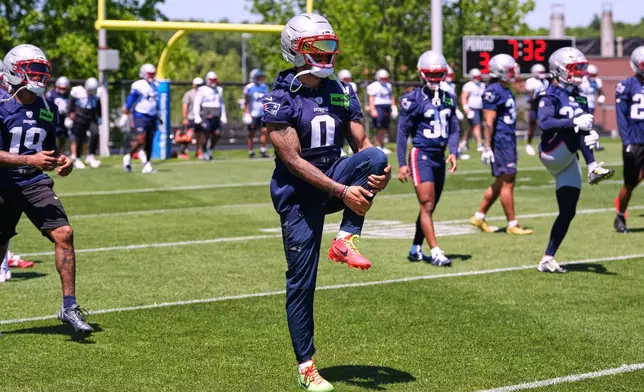 New England Patriot's Christian Gonzalez stretches during an NFL football practice, Tuesday, June 9, 2026, in Foxborough, Mass. (AP Photo/Charles Krupa)