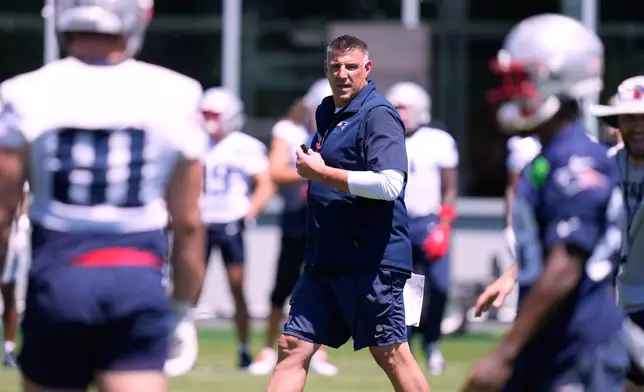 New England Patriot's head coach Mike Vrabel talks with players during an NFL football practice, Tuesday, June 9, 2026, in Foxborough, Mass. (AP Photo/Charles Krupa)