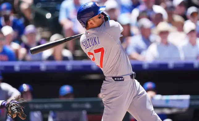 Chicago Cubs' Seiya Suzuki follows the flight of his grand slam off Colorado Rockies starting pitcher Ryan Feltner in the fourth inning of a baseball game Thursday, June 11, 2026, in Denver. (AP Photo/David Zalubowski)