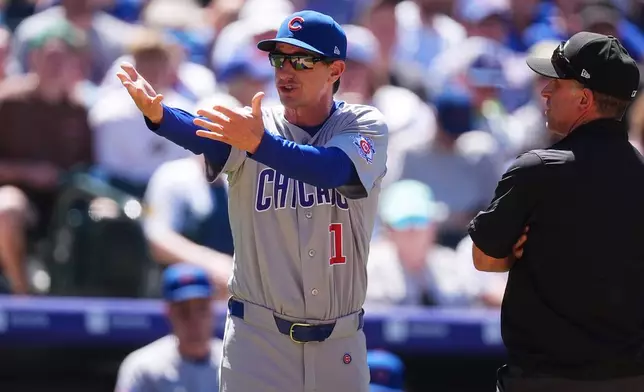 Chicago Cubs manager Craig Counsell, left, argues with second base umpire David Rackley after Chicago Cubs designated hitter Moisés Ballesteros hit into a double play in the sixth inning of a baseball game against the Colorado Rockies, Thursday, June 11, 2026, in Denver. (AP Photo/David Zalubowski)