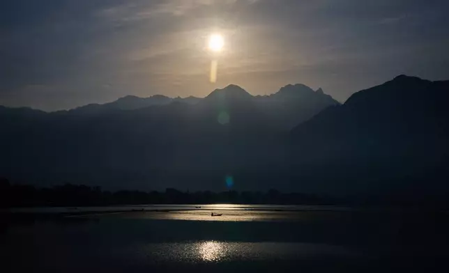 A Kashmiri fisher rows his boat at dawn on Dal Lake on the outskirts of Srinagar, Indian controlled Kashmir, Monday, May 4, 2026. (AP Photo/Dar Yasin)