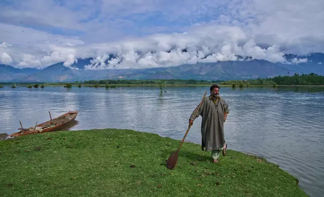 Bashir Ahmed, a Kashmiri fisher, stands on an island in Wular Lake in Bandipora, northeast of Srinagar, Indian controlled Kashmir, Tuesday, May 5, 2026. (AP Photo/Dar Yasin)