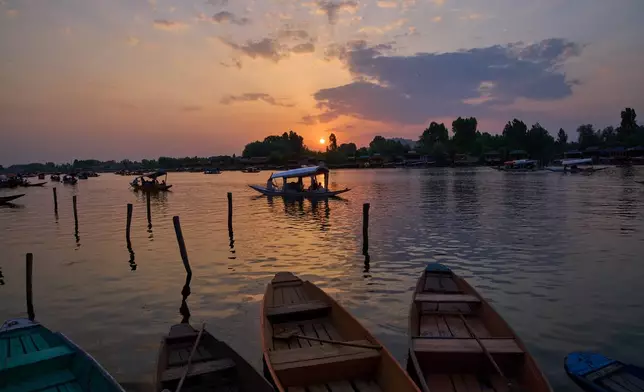 Tourists enjoy a ride on a traditional boat at sunset on Dal Lake in Srinagar, Indian controlled Kashmir, Monday, June 1, 2026. (AP Photo/Dar Yasin)