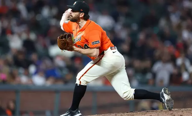 San Francisco Giants pitcher Ryan Walker throws to a Chicago Cubs batter during the ninth inning of a baseball game Friday, June 12, 2026, in San Francisco, Calif. (AP Photo/Scott Marshall)