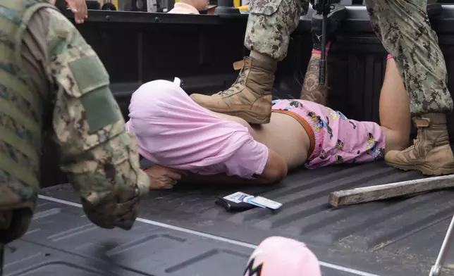 FILE - An unidentified man is detained by soldiers during a military operation in Guayaquil, Ecuador, Jan. 18, 2024. (AP Photo/Cesar Munoz, File)