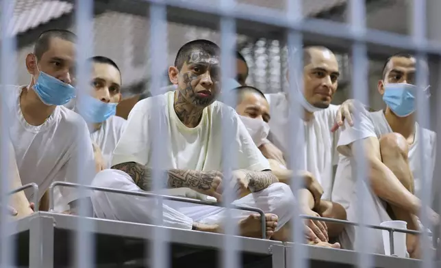 FILE - Prisoners look out from their cell as the Costa Rica Justice and Peace minister tours the Terrorism Confinement Center in Tecoluca, El Salvador, April 4, 2025. (AP Photo/Salvador Melendez, File)