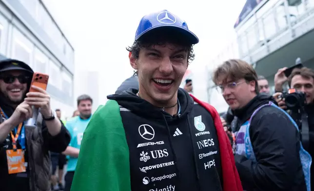 Winner Mercedes driver Kimi Antonelli, center, of Italy, smiles after being sprayed by his team following the F1 Canadian Grand Prix auto race in Montreal, Sunday, May 24, 2026. (Christopher Katsarov/The Canadian Press via AP)
