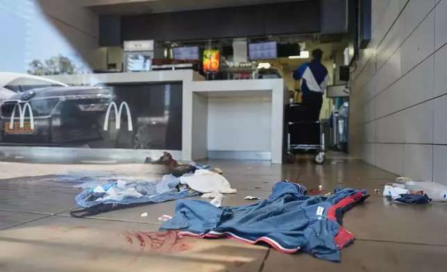 Blood stains are visible at the scene of what Israeli police say was a series of shooting attacks carried out by a Palestinian citizen of Israel in Kochav Yair, central Israel, Sunday, June 7, 2026. (AP Photo/Ariel Schalit)