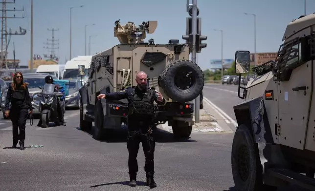 Israeli police officers are deployed at the scene of a shooting attack carried out by a Palestinian citizen of Israel near Tzur Yitzhak in central Israel, Sunday, June 7, 2026. (AP Photo/Ariel Schalit)