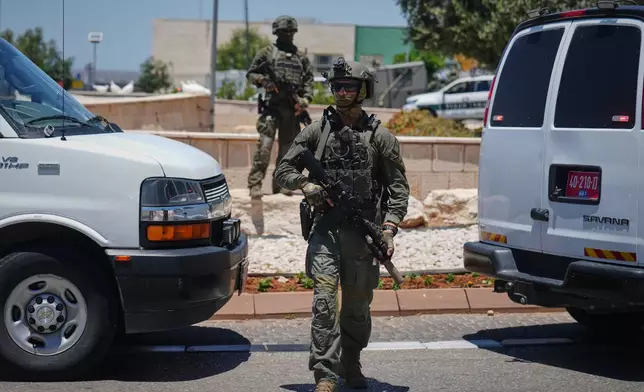 Israeli security forces are deployed at the scene of a shooting attack carried out by a Palestinian citizen of Israel near Tzur Yitzhak in central Israel, Sunday, June 7, 2026. (AP Photo/Ariel Schalit)