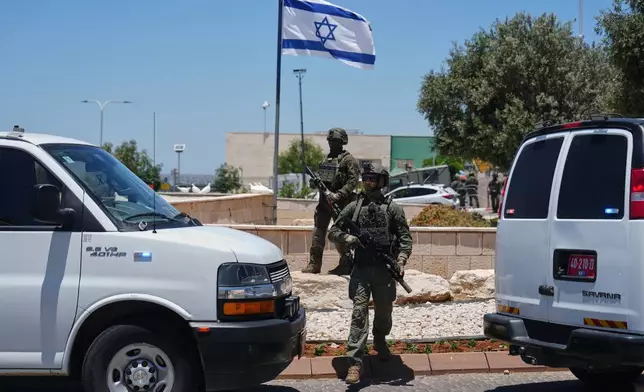 Israeli security forces are deployed at the scene of a shooting attack carried out by a Palestinian citizen of Israel near Tzur Yitzhak in central Israel, Sunday, June 7, 2026. (AP Photo/Ariel Schalit)