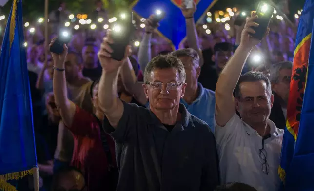 Supporters wave their lights at the closing political rally of the Democratic League of Kosovo (LDK), in capital Pristina on Friday, June 5, 2026. (AP Photo/Visar Kryeziu)