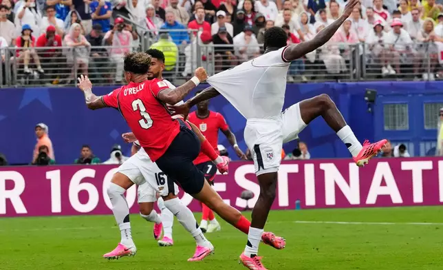 England's Nico O'Reilly (3) pulls the shirt of Panama's Jose Cordoba (3) during the World Cup Group L soccer match between Panama and England in East Rutherford, N.J., near New York, Saturday, June 27, 2026. (AP Photo/Yuki Iwamura)