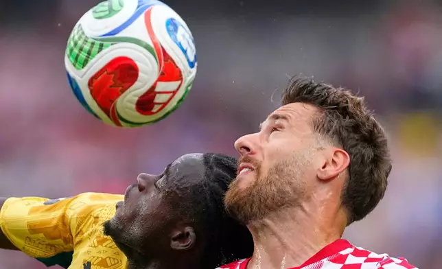 Ghana's Kamaldeen Sulemana (22), left, heads for the ball with Croatia's Nikola Vlasic (13) during the World Cup Group L soccer match between Croatia and Ghana in Philadelphia, Saturday, June 27, 2026. (AP Photo/Petr Josek)