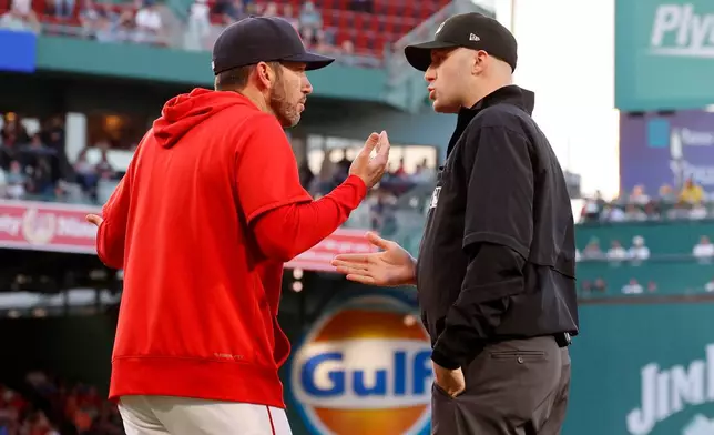 Boston Red Sox interim manager Chad Tracy, left, argues with umpire Nic Lentz, right, after Lentz ejected Red Sox's Willson Contreras for contesting a call during the second inning of a baseball game against the Washington Nationals, Monday, June 29, 2026, in Boston. (AP Photo/Mary Schwalm)