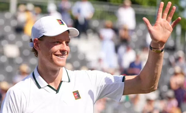 Jannik Sinner of Italy waves to supporters after a tennis exhibition match against Cameron Norrie of Great Britain at the Hurlingham Tennis Club in London, Wednesday, June 24, 2026.(AP Photo/Kirsty Wigglesworth)