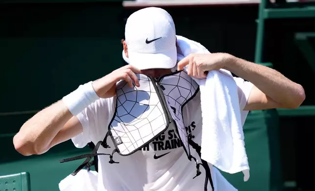 Italy's Jannik Sinner wears an ice jacket to keep cool during a practice session ahead of the Wimbledon Tennis Championships, at the All England Lawn Tennis and Croquet Club, in London, Wednesday June 24, 2026. (John Walton/PA via AP)