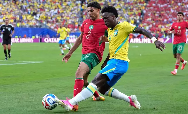 Brazil's Vinicius Junior (7) challenges for the ball with Morocco's Achraf Hakimi (2) during the World Cup Group C soccer match between Brazil and Morocco in East Rutherford, N.J., near New York, Saturday, June 13, 2026. (AP Photo/Yuki Iwanmura)